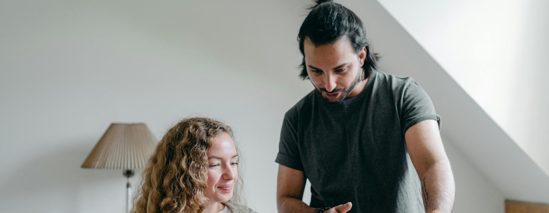 a man and a woman looking at a laptop