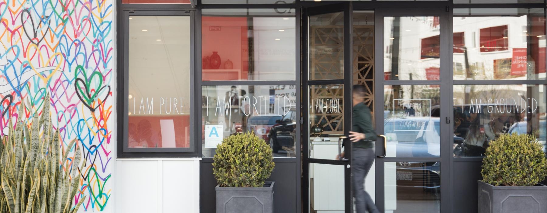 a person walking into a cafe
