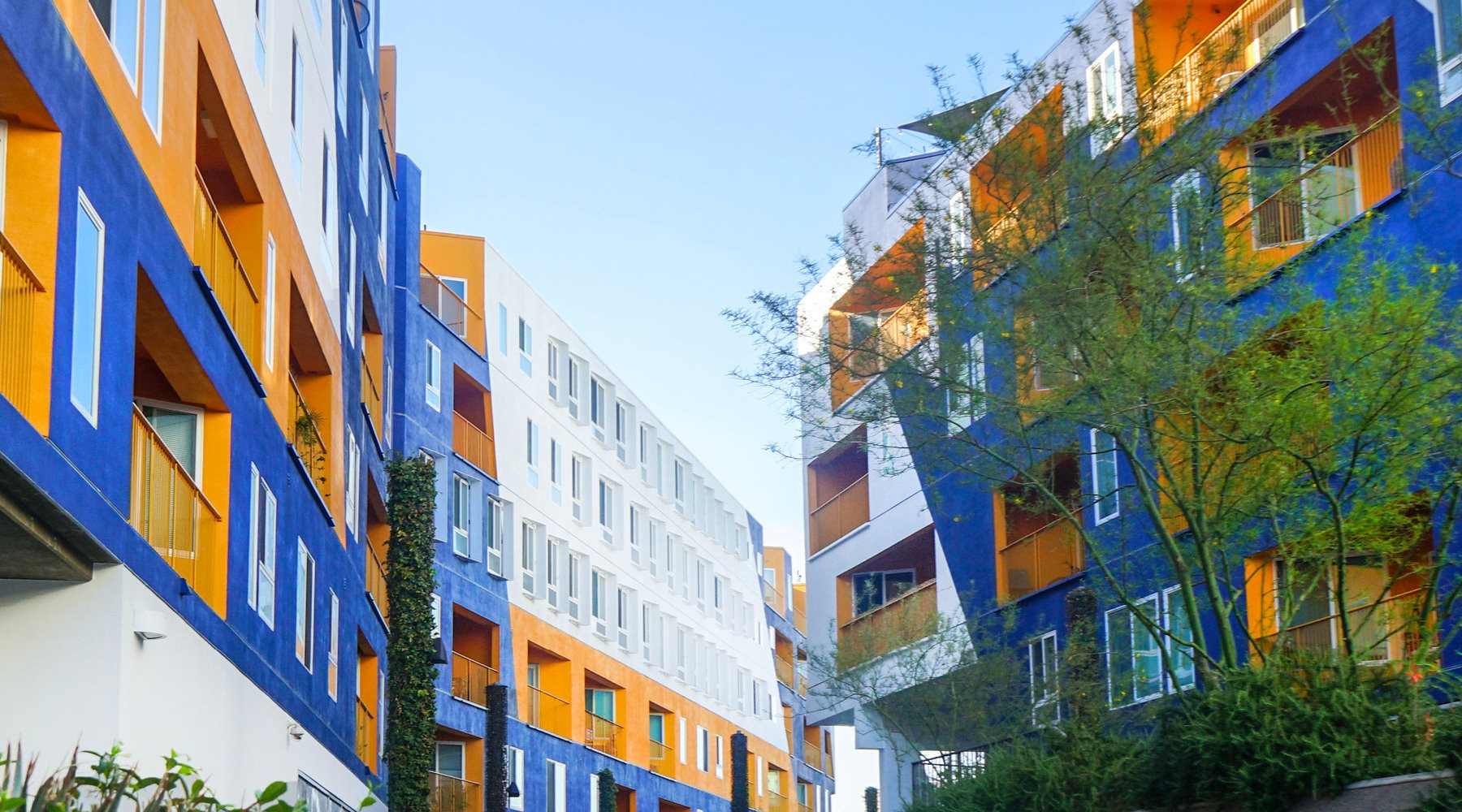 The essence of exceptional living blue and yellow buildings with landscaping
