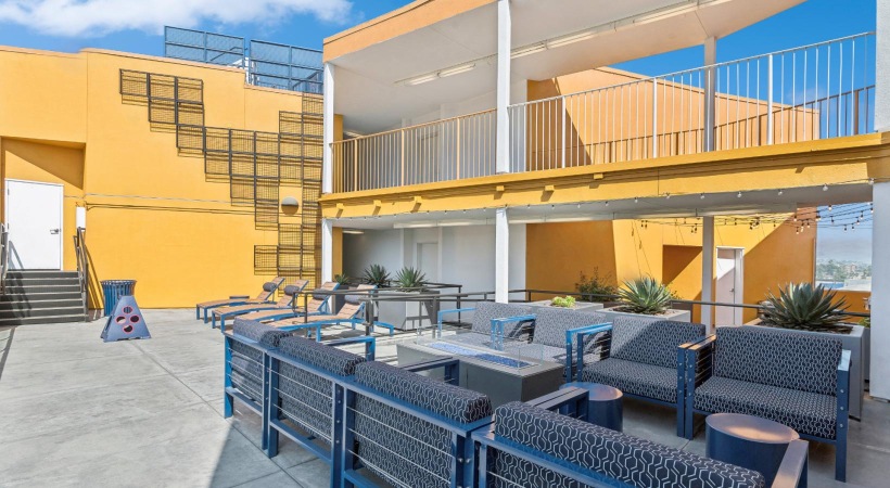 a patio with seating and fire place