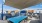 covered outdoor patio with grills a table and chairs