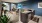 a kitchen with a bar and view of a living room