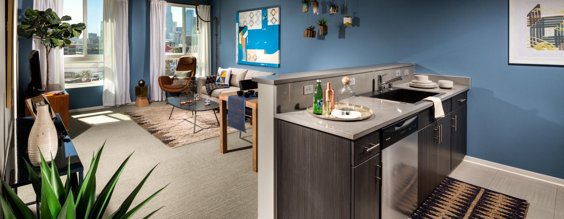 a kitchen with a bar and view of a living room