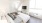 a bedroom with bed tv and large windows