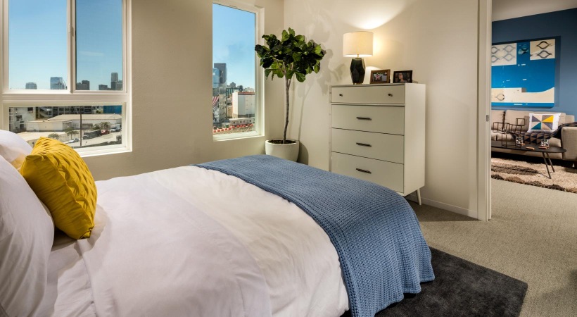 a bedroom with a bed and a lamp
