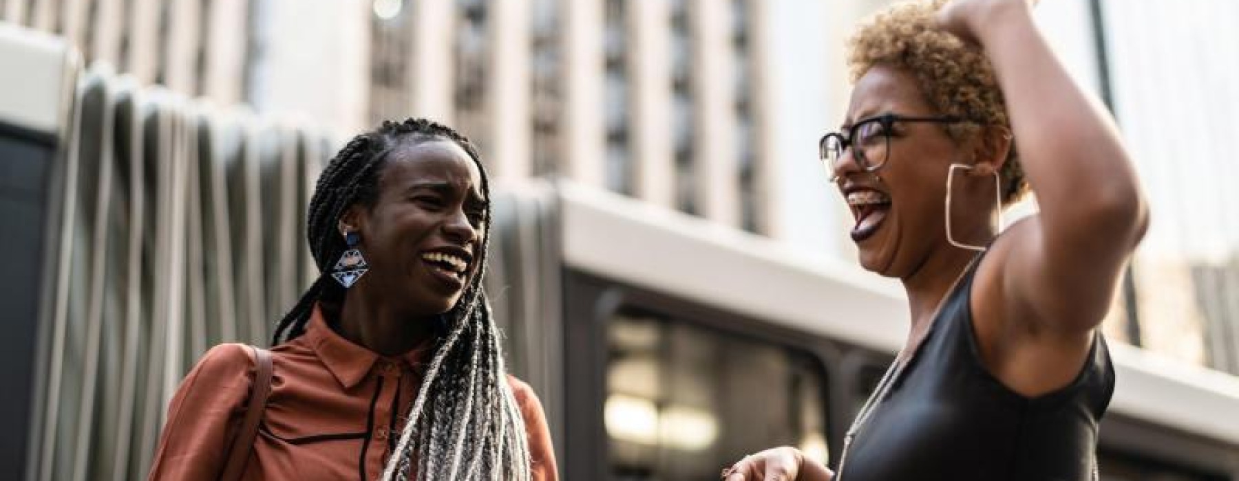 women laughing together in the city